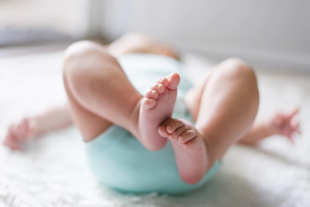 baby in a light blue onesie 