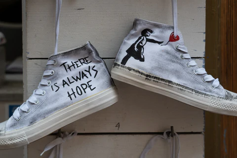 banksy's printed artwork on the sneakers