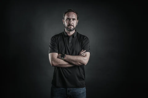 a man wearing a black polo shirt