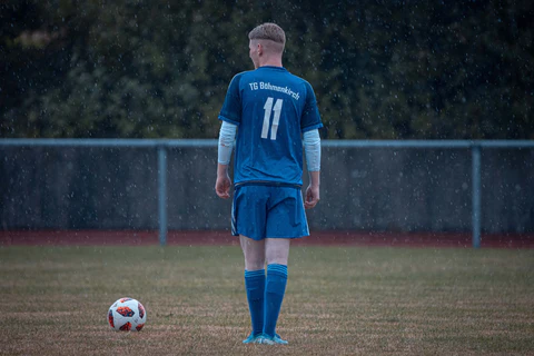 a footballer in a blue jersey