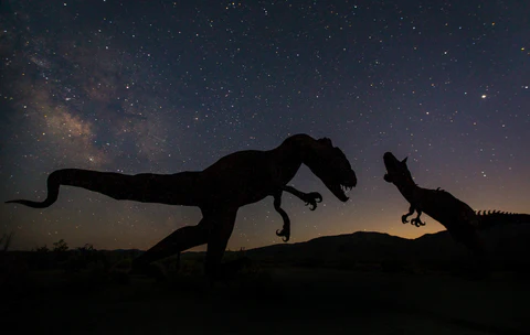 two dinosaurs in the dark