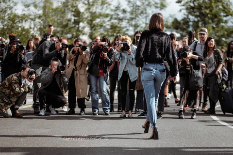a model and the photographers at the london fashion week