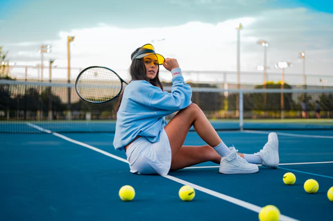 girl wears tennis clothes on the courts