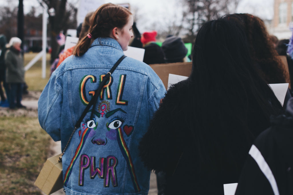 a woman in a 'girl power' jacket