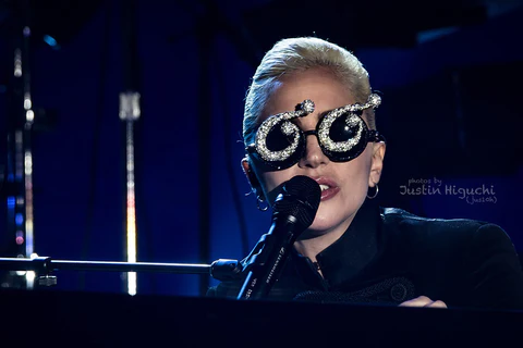 lady gaga singing and playing a piano