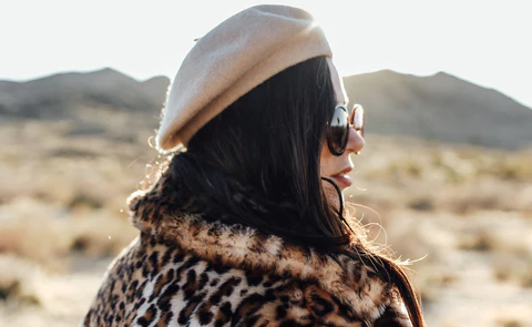 a woman wearing a leopard printed coat