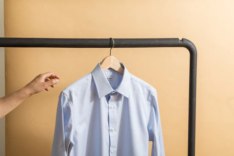 a light blue collar shirt on the hanger