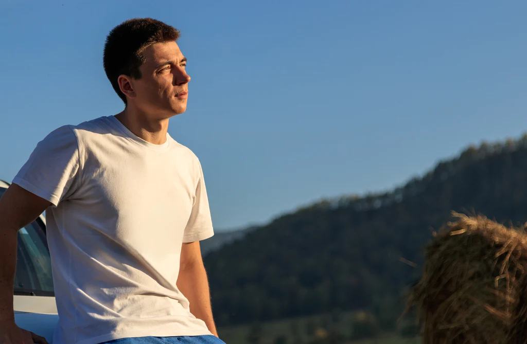 man in nature, wearing a casual white t-shirt