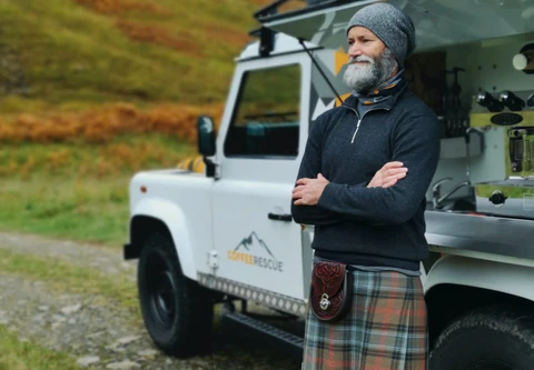a standing man wearing kilt