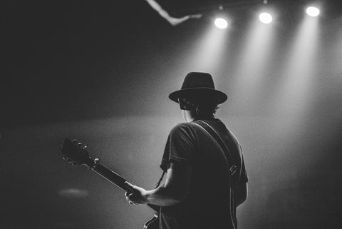 man on a stage with a guitar 