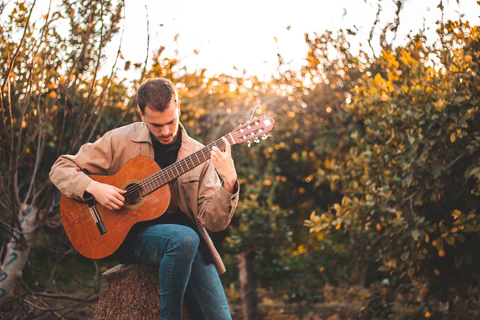 a man with a guitar in nature