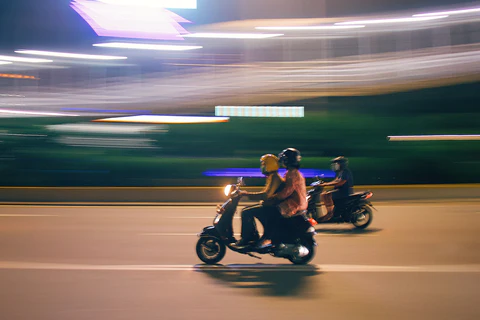 riding a moped at night