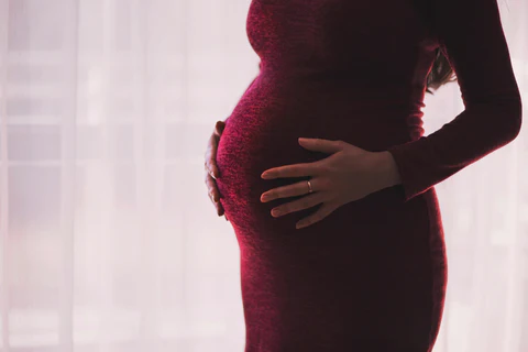 a pregnant woman in a red dress