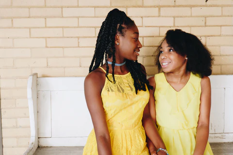 sisters wearing a yellow dresses