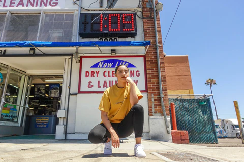 girl in a yellow t-shirt and white sneakers