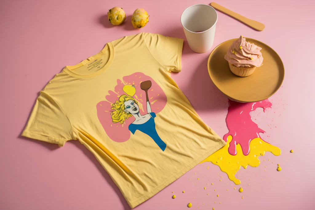 yellow t-shirt on a pink table with food