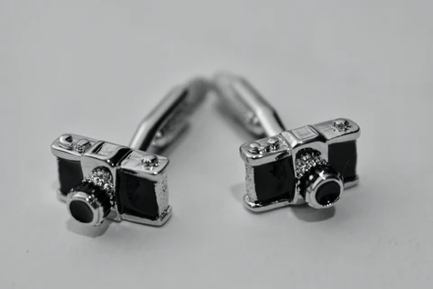 a pair of camera cufflinks