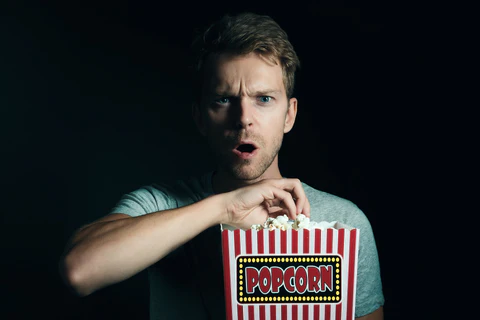 a man watches a horror movie