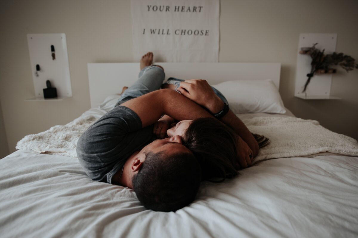 a couple wearing clothes in bed